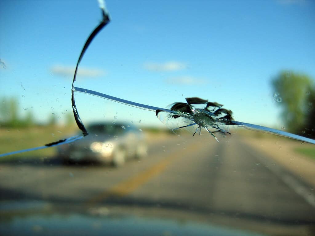 Vehicle windshield with impact damage, highlighting the importance of timely windshield repair and safety.